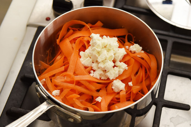 Then tossing the cooked quinoa with carrot ribbons and goat cheese while it's still hot.