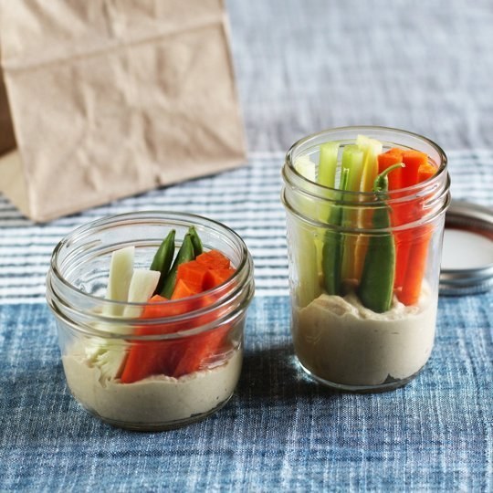 Chop celery and carrots into sticks, and create little hummus and veggie snack jars.
